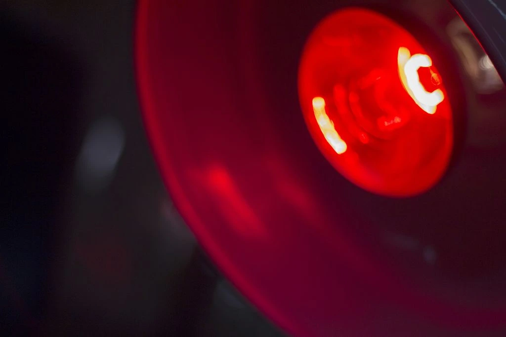 A red light bulb that is powered on