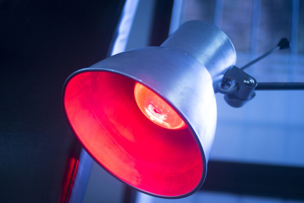heating lamp with red glowing light emitting from bulb